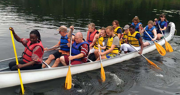 twelve people rowing a large boat, L'Arche in Quebec